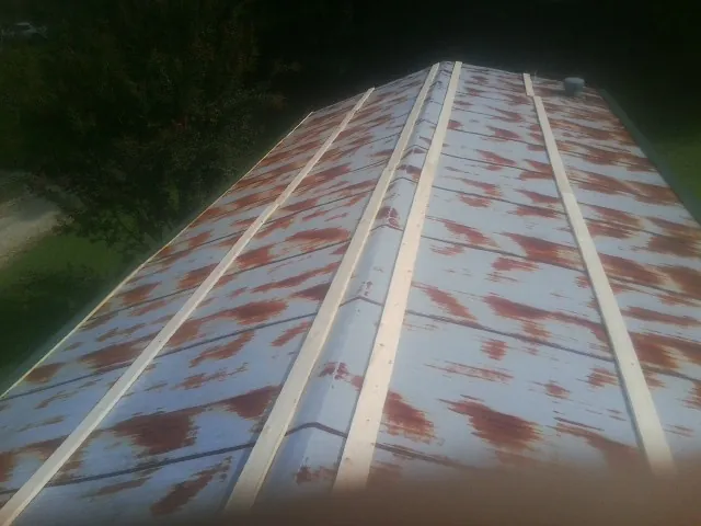 Rusted metal roof panels with new wood purlins before replacement — Storm Damage Roof Repair in Bowie by Roofing Brothers